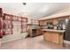 Bright kitchen with stainless steel appliances, tile backsplash, kitchen island and stylish light fixtures at 1858 N 128Th Dr, Avondale, AZ 85392