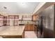 Bright kitchen with stainless steel appliances, tile backsplash, kitchen island, and tile flooring at 1858 N 128Th Dr, Avondale, AZ 85392
