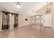 Spacious living room featuring vaulted ceilings, neutral paint, tile flooring, and great natural light at 1858 N 128Th Dr, Avondale, AZ 85392
