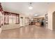 Open-concept space with tile flooring, neutral paint and access to the kitchen at 1858 N 128Th Dr, Avondale, AZ 85392