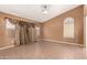 Spacious living room with tile flooring, neutral walls, and bright windows at 1858 N 128Th Dr, Avondale, AZ 85392