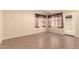 Bright living room with neutral paint, tile flooring, and a view to the backyard at 1858 N 128Th Dr, Avondale, AZ 85392