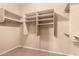 Walk-in closet with multiple shelves and tile flooring at 1858 N 128Th Dr, Avondale, AZ 85392