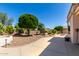 Lush backyard featuring mature landscaping and a spacious concrete patio, perfect for outdoor entertaining at 20017 N Cielo Ct, Surprise, AZ 85374