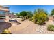 Serene backyard showcasing a fire pit, desert landscaping, and a view of the home at 20017 N Cielo Ct, Surprise, AZ 85374