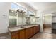 Bright bathroom features double vanity, large mirrors, and walk-in closet with storage at 20017 N Cielo Ct, Surprise, AZ 85374