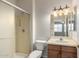 Bathroom featuring a shower, toilet, vanity with cabinets, and updated lighting at 20017 N Cielo Ct, Surprise, AZ 85374