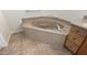 Comfortable bathtub featuring stone surround and tile floors at 20017 N Cielo Ct, Surprise, AZ 85374