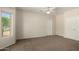 Spacious bedroom with neutral walls, plush carpet, and natural light from window at 20017 N Cielo Ct, Surprise, AZ 85374