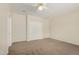 Neutral bedroom featuring carpet, ceiling fan and a spacious closet at 20017 N Cielo Ct, Surprise, AZ 85374
