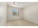 Simple bedroom featuring carpet, ceiling fan and a large window at 20017 N Cielo Ct, Surprise, AZ 85374