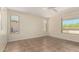 Bright, neutral bedroom featuring tile flooring, multiple windows, and ample light at 20017 N Cielo Ct, Surprise, AZ 85374