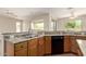Charming kitchen featuring wooden cabinets, granite countertops, and modern appliances at 20017 N Cielo Ct, Surprise, AZ 85374