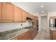 Well-lit kitchen with laminate countertops, light wood cabinets, and modern appliances at 20017 N Cielo Ct, Surprise, AZ 85374