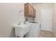 Functional laundry room featuring a sink, cabinet, washer, and dryer at 20017 N Cielo Ct, Surprise, AZ 85374