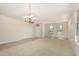 Bright living room featuring carpet flooring, large windows, and a ceiling fan at 20017 N Cielo Ct, Surprise, AZ 85374