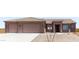 Charming one-story home features a three-car garage and neutral colored exterior with minimal landscaping at 217Xx W Buck Ln, Wittmann, AZ 85361
