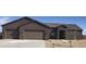 Attractive single-story home with a three-car garage and desert landscaping in a peaceful setting at 217Xx W Buck Ln, Wittmann, AZ 85361