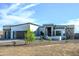 Modern single-story home displaying a two-car garage and desert landscaping for a sophisticated look at 217Xx W Buck Ln, Wittmann, AZ 85361