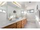 Bathroom featuring double sinks, a large mirror, shower-tub combination, and tile flooring at 29670 N 46Th St, Cave Creek, AZ 85331