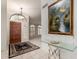 Welcoming entryway featuring a wood door, neutral tile flooring and elegant decor at 29670 N 46Th St, Cave Creek, AZ 85331