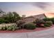 Single-story home with a three-car garage and desert landscaping at dusk at 29670 N 46Th St, Cave Creek, AZ 85331
