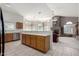 Open kitchen and living space featuring a stone fireplace and large windows at 29670 N 46Th St, Cave Creek, AZ 85331