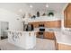 Bright kitchen features stainless steel appliances, tile flooring, and a decorative gecko accent on the breakfast bar at 29670 N 46Th St, Cave Creek, AZ 85331