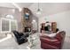 Open living room with a stone fireplace, vaulted ceilings, and comfortable seating at 29670 N 46Th St, Cave Creek, AZ 85331