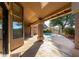 Covered patio with view of the pool and backyard featuring manicured landscaping and desert trees at 29670 N 46Th St, Cave Creek, AZ 85331