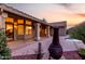 Covered patio features tile roof, outdoor fireplace, and beautiful sunset view in the backyard at 29670 N 46Th St, Cave Creek, AZ 85331
