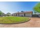 Well-maintained backyard featuring lush grass, a gravel path, and a charming residence in the background at 3433 E Betty Elyse Ln, Phoenix, AZ 85032