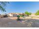 Large backyard with gravel, charming trees, a fire pit, and potential for outdoor activities at 3433 E Betty Elyse Ln, Phoenix, AZ 85032