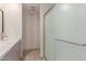 Bathroom featuring a shower with glass door, neutral walls, and modern vanity at 3433 E Betty Elyse Ln, Phoenix, AZ 85032