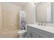Bathroom featuring a bathtub with shower, toilet, single sink, and mirror at 3433 E Betty Elyse Ln, Phoenix, AZ 85032