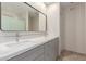 Bathroom featuring double sinks, modern fixtures, vanity with grey cabinets, and large mirror at 3433 E Betty Elyse Ln, Phoenix, AZ 85032