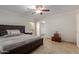 Bright bedroom featuring a ceiling fan, window, neutral walls, and tiled floor at 3433 E Betty Elyse Ln, Phoenix, AZ 85032