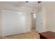 Bedroom featuring a closet, neutral walls, and tiled floor at 3433 E Betty Elyse Ln, Phoenix, AZ 85032