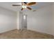 Bedroom featuring a ceiling fan, tiled floor, and doorway to hallway at 3433 E Betty Elyse Ln, Phoenix, AZ 85032