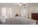 Bedroom showcasing neutral walls, tiled floor, ceiling fan, and doorway to hallway at 3433 E Betty Elyse Ln, Phoenix, AZ 85032