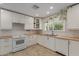 Bright kitchen featuring white cabinets, wood countertops, stainless steel appliances, and modern fixtures at 3433 E Betty Elyse Ln, Phoenix, AZ 85032