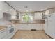 Bright kitchen with white cabinets, wood countertops, stainless steel appliances, and a view to the backyard at 3433 E Betty Elyse Ln, Phoenix, AZ 85032