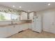 Bright kitchen featuring white cabinets, wood countertops, stainless steel appliances, and neutral tile floors at 3433 E Betty Elyse Ln, Phoenix, AZ 85032