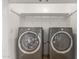 This is a laundry room with an Electrolux washer and dryer and a white shelf above at 3433 E Betty Elyse Ln, Phoenix, AZ 85032