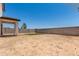 A spacious backyard shows a patio and minimal landscaping at 36025 W Santa Clara Ave, Maricopa, AZ 85138