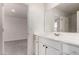 Well-lit bathroom features a modern vanity, ample counter space, and a shower-tub combination at 36025 W Santa Clara Ave, Maricopa, AZ 85138