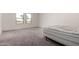 A bedroom features neutral carpet and a mattress against a window at 36025 W Santa Clara Ave, Maricopa, AZ 85138