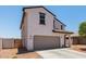 Side angle of a two-story home featuring an attached two-car garage at 36025 W Santa Clara Ave, Maricopa, AZ 85138