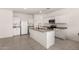 Spacious kitchen featuring white cabinets, granite countertops, and stainless steel appliances at 36025 W Santa Clara Ave, Maricopa, AZ 85138