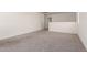 The spacious living room includes neutral carpet and walls, and a doorway at 36025 W Santa Clara Ave, Maricopa, AZ 85138